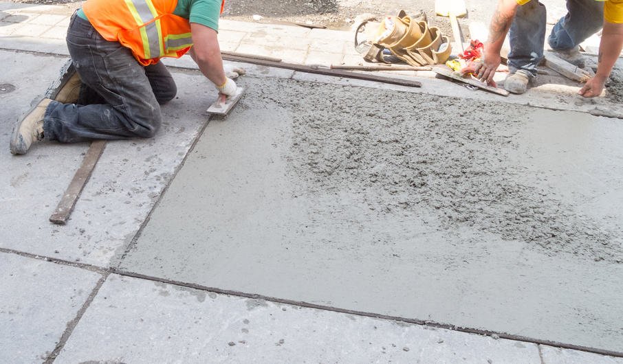 Laying down new pavement in residential neighborhood - Durham Concrete Contractors